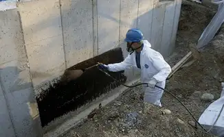Professional waterproofing the exterior walls of the basement in Tucson, AZ