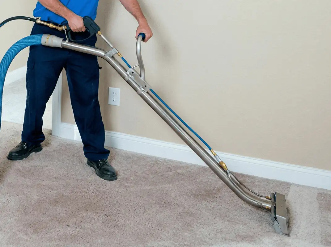 Professional operating a liquid removal machine on a carpeted floor in Tucson, AZ